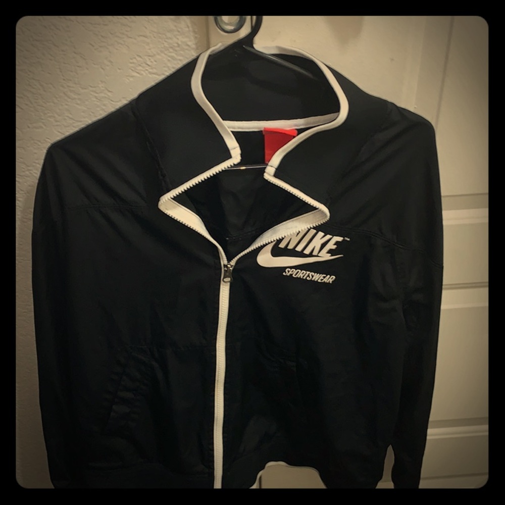 A Nike windbreaker that is black and white.